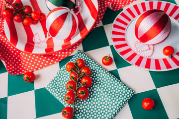 Festive table with colorful decor and tomatoes