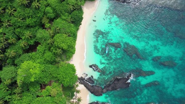 Image rising of the beautiful beach cafe (coffee) with a boat anchored in the magnificent transparent sea at Ilh&eacute;u das Rolas.S&atilde;o Tom&eacute;,Africa