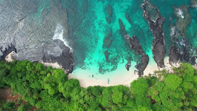 Descending over a boat anchored at the sand of praia caf&eacute; (coffee beach) with amazing turquoise sea at ilheu das rolas,S&atilde;o Tom&eacute;,Africa