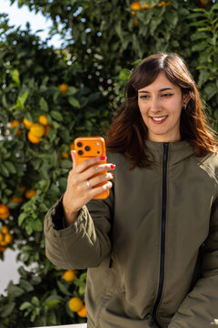 Woman with orange smartphone