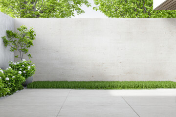 Modern outdoor space with concrete wall, plants, and grass in bright daylight with clear blue sky above