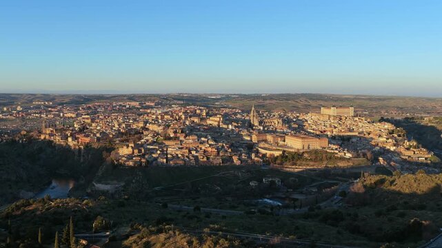 Wide orbit capturing village geographic isolation on the Tagus meander with the Montes de Toledo range extending southeast and the flat Castilian plateau forming distant horizon.