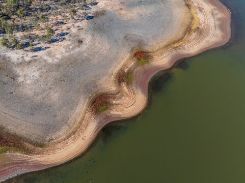 Abstract patterns of land and vegetation around a drying reservoir