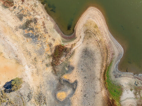 Abstract patterns of land and vegetation around a drying reservoir