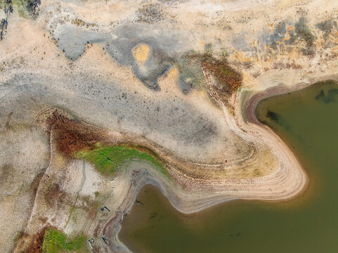 Abstract patterns of land and vegetation around a drying reservoir
