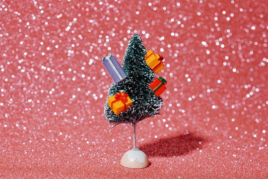 a small christmas tree decorated with colorful gifts
