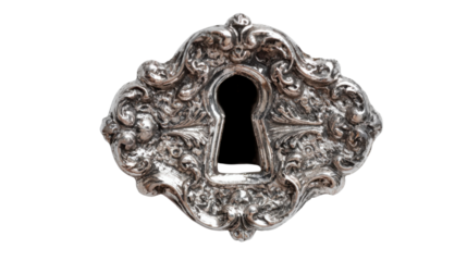 Ornate antique silver keyhole escutcheon creating a sense of mystery, secret, and history from the past
