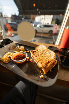 Half Sandwich With Chips and Sauce at Coffee Shop Window Table