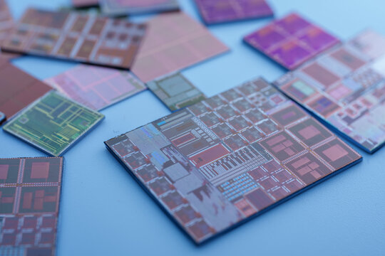 Microchips and Circuit Boards Spread out on Blue Surface