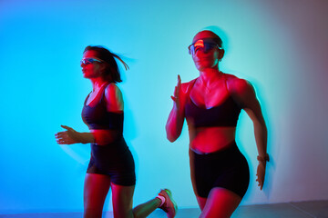 Women jogging indoors with vibrant lighting and dynamic movement