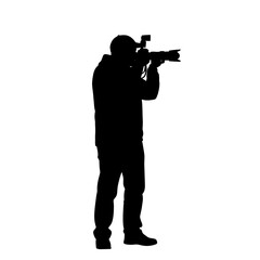 Silhouette of a cameraman filming with a professional video camera and external flash