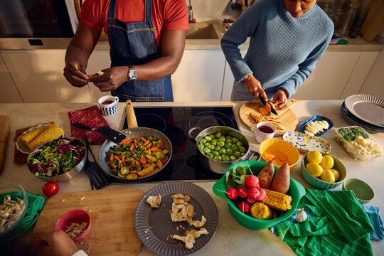 Man and woman preparing food at home