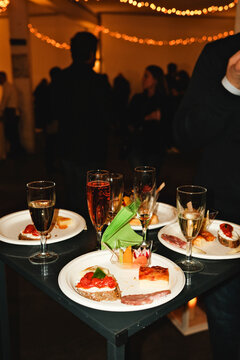 Table with drinks and aperitif plates at a social event
