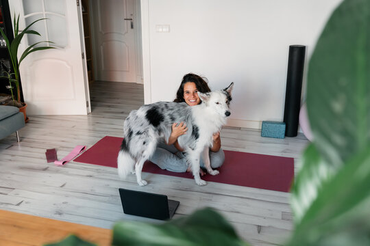 Woman hugging her border collie at home