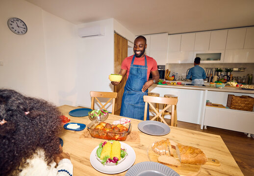 Father serves food on the table