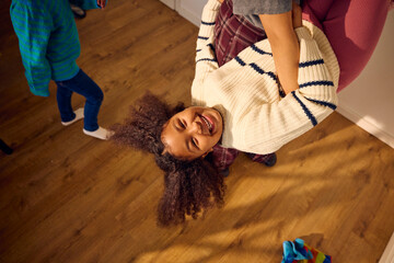 Parent engages in playful activities with her daughter