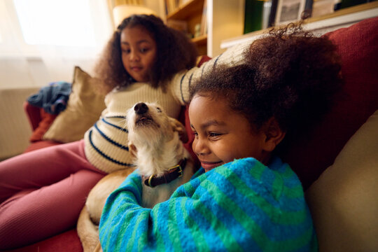 Little girls spend time with their dog at home