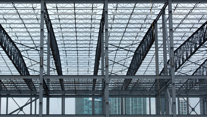 Construction shows steel framework structure. Construction reveals modern urban development. Construction represents industrial growth process. Construction creates strong geometric lines.