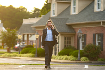 A realtor hands keys to a homeowner. Real estate agent inspects an apartment interior. Agent explains property financing. A real estate broker stands confidently outside a residential building. © Volodymyr