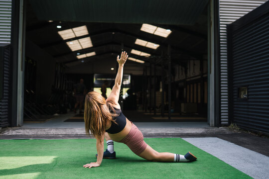 Pregnant woman stretching during functional fitness training session