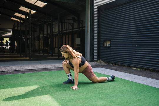 Pregnant woman stretching during functional training workout