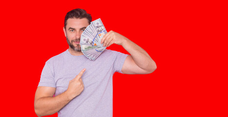 Portrait business man holding cash dollar bills over red studio background. Big luck, banner. Dollar cash money concept. Rejoices to win cash. Man hold cash money. Financial luck and success.