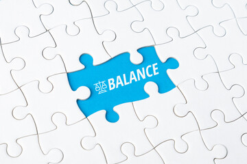 Conceptual jigsaw puzzle with a missing piece revealing the word BALANCE, symbolizing the harmony between online connectivity and real life, mental wellness, and digital detox strategies.