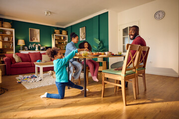 Little girl plays with her dad during lunch