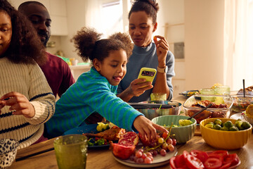Family of four enjoying lunch together