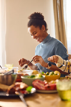 Happy woman eats at the table