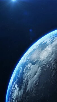 cinematic earth horizon with blue atmosphere and sunrise light in deep space. vertical video