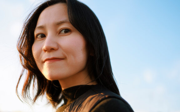 Golden Hour Smile: Optimistic Female Portrait Facing the Future.
