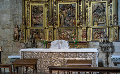 Altar with ornate decorations and wooden benches.. Orense Cathedral, Spain