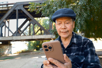 senior asian man using mobile phone device