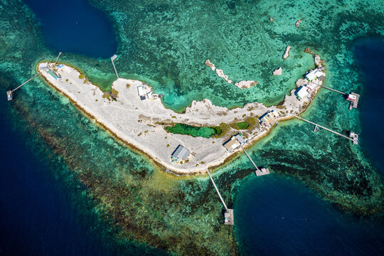 Remote coral cay with vivid turquoise shallows