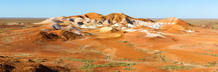 Sunlit ochre hills rising from the wide open plains