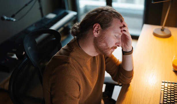 Stressful work moment caught in urban home office setting
