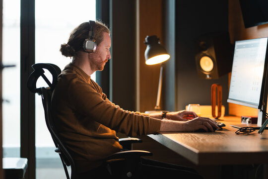 Man working at computer with headphones
