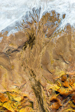 Eroded ridgelines spilling into pale salt flats