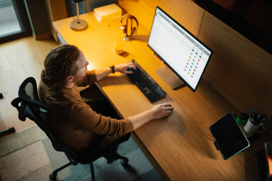 Working late at night in a modern home office setup
