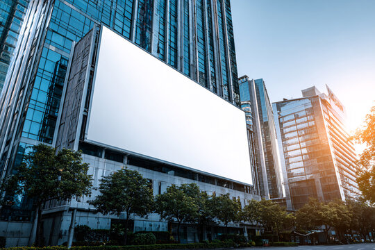 Large horizontal blank advertising poster billboard banner mockup in front of building in urban city digital light box display screen for media outofhome