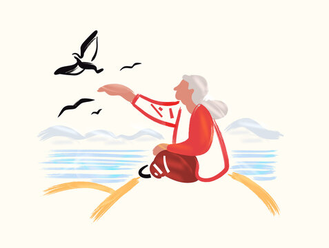Senior woman sitting by the sea and feeding birds