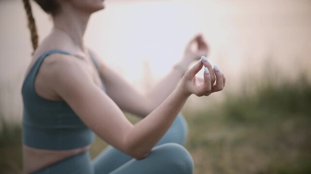 Yogi Meditating In Lotus Position Near River. Yoga Zen Meditation In Park. Spiritual Mental Health Wellness Exercise