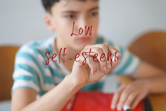 LOW SELF-ESTEEM. Mental health in childhood and adolescence concepts. Preteen boy writing text