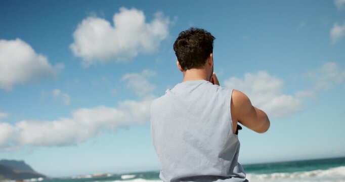 Back, beach and man with workout, stretching and wellness with stress relief, morning routine and balance. Ocean, training and healthy person with breathing exercise, challenge or warm up in Zanzibar