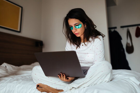 Woman Working on a Laptop With Under Eye Patches