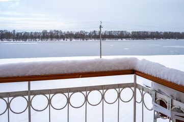 Snow on the balcony railing during heavy snowfall.