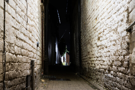 An old alleyway in a town at night