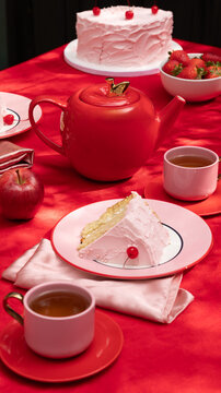 Pink Cake Slice and Tea on Red Silk Tablecloth
