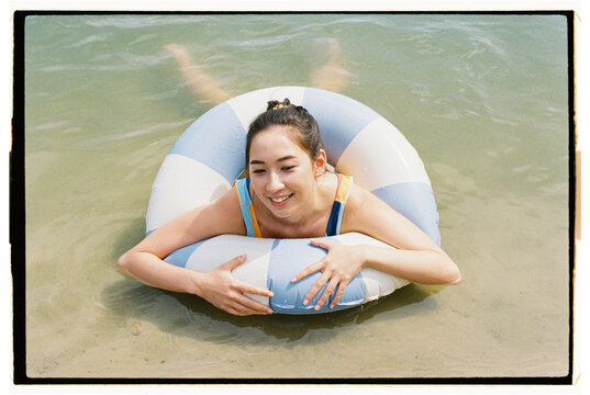 Relaxing on the beach with a colorful inflatable ring